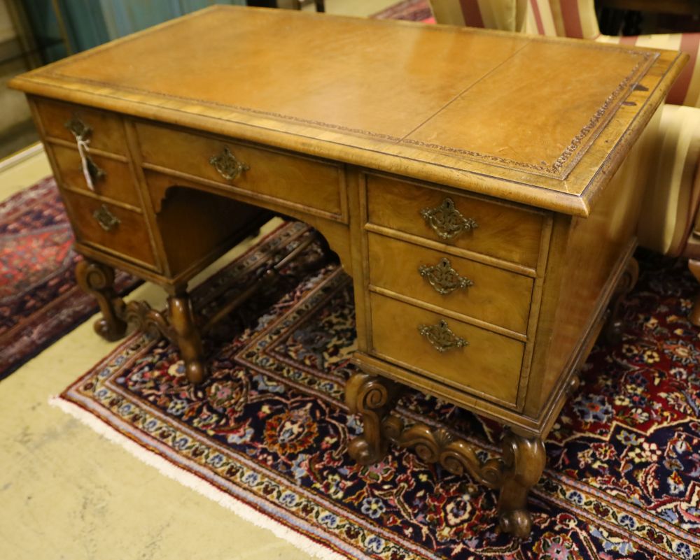 A Queen Anne style walnut kneehole desk, width 128cm, depth 70cm, height 76cm